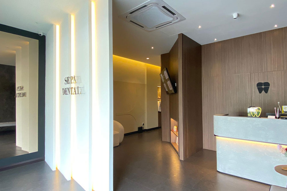 Modern dental clinic hallway with treatment rooms and seating area