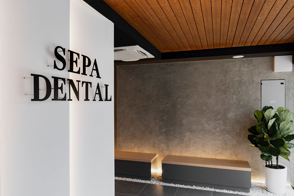 Modern dental clinic hallway with treatment rooms and seating area