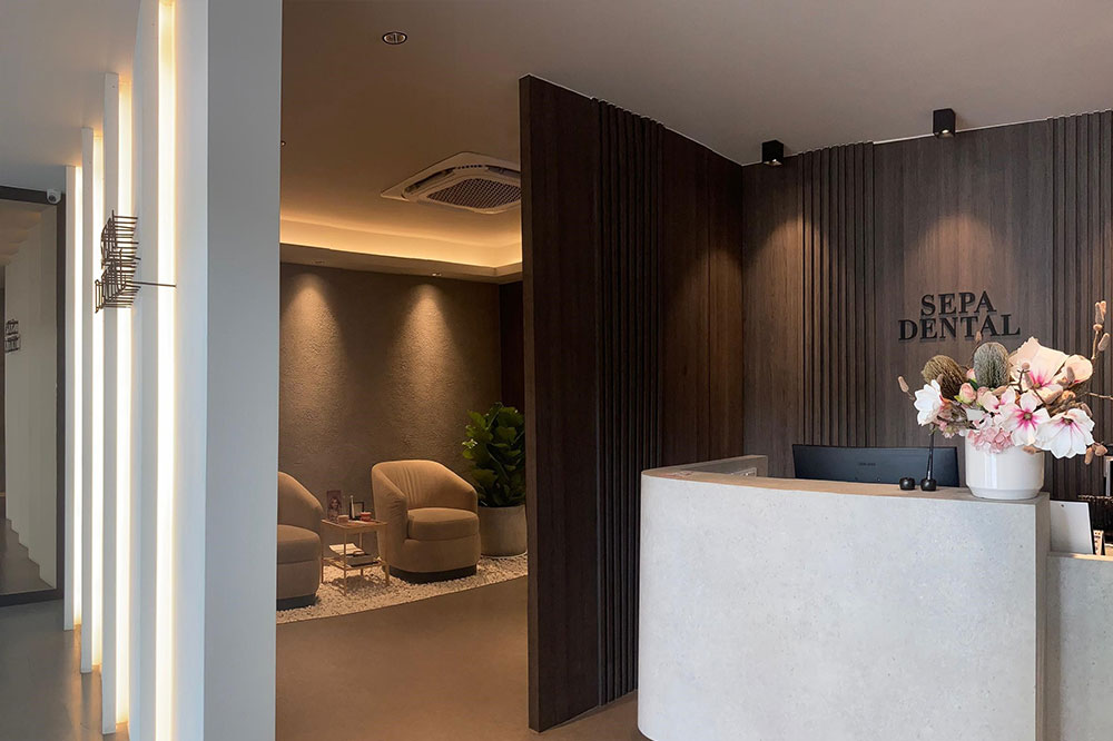 Modern dental clinic hallway with treatment rooms and seating area