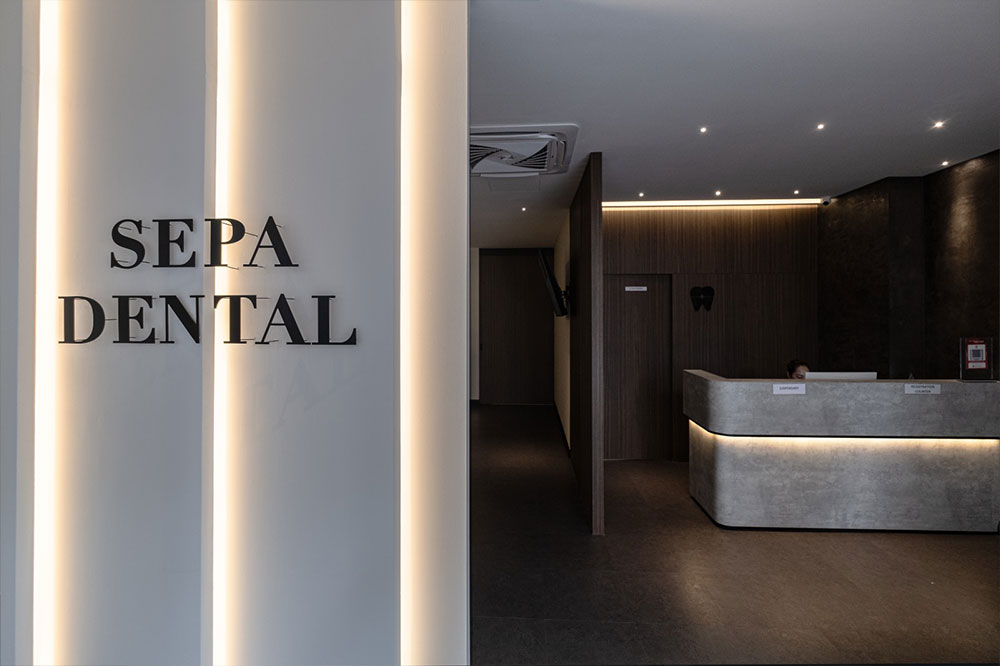 Modern dental clinic hallway with treatment rooms and seating area
