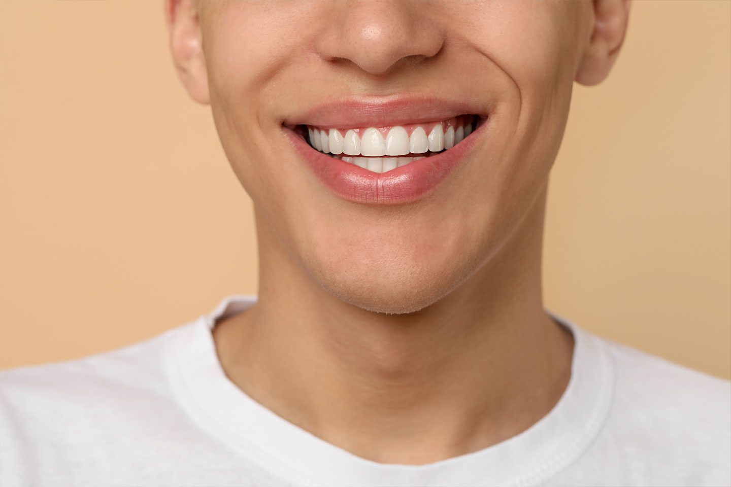 A person smiling with a perfect set of teeth
